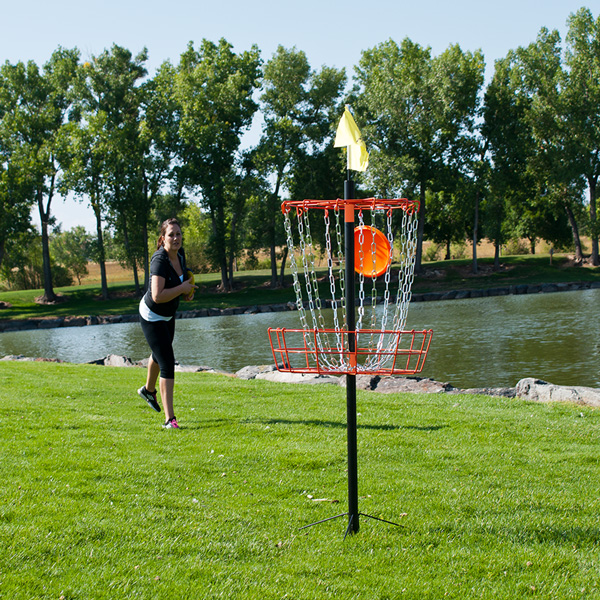 Portable Disc Golf Target Basket at park near water hazard